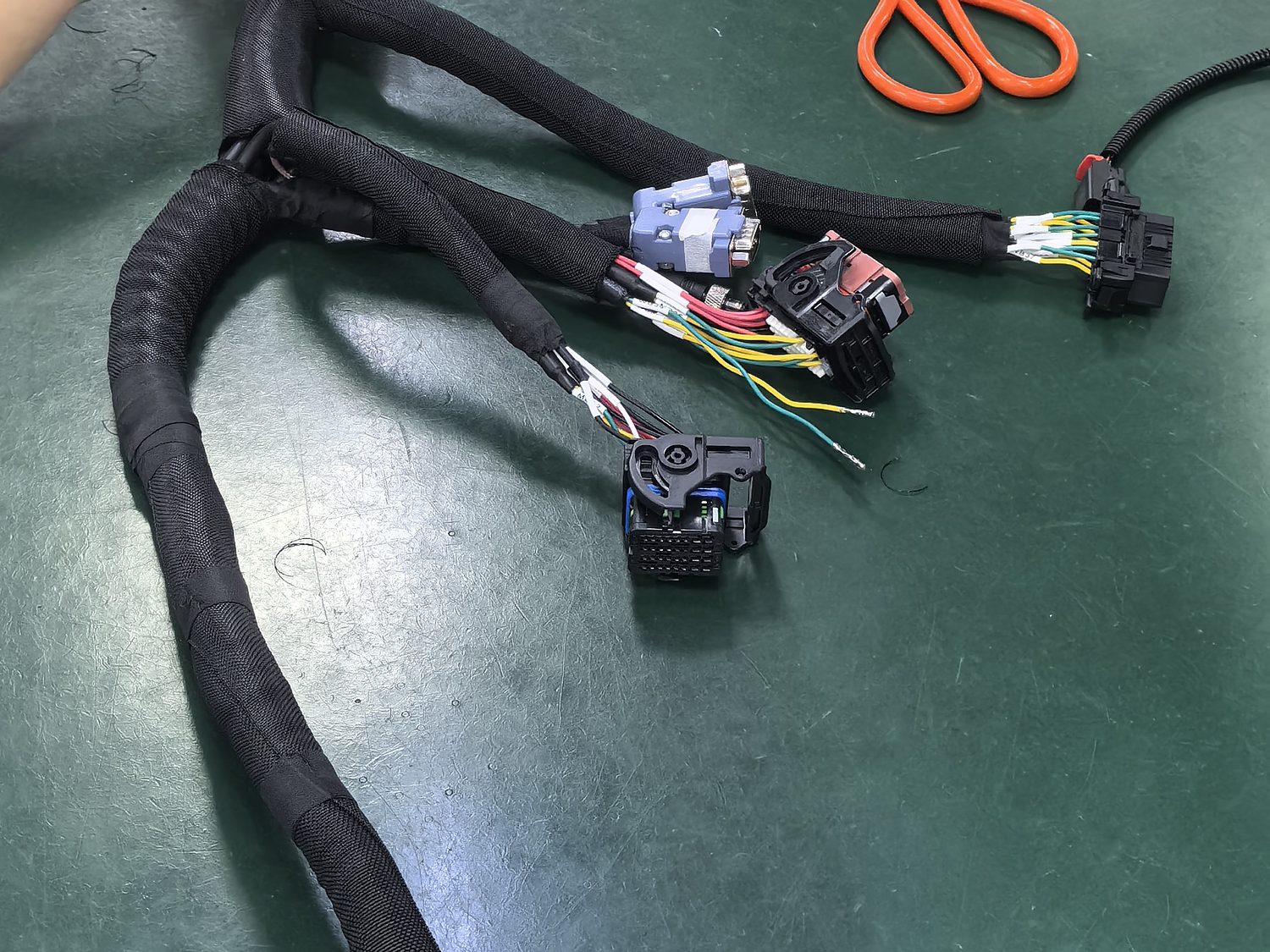 Sleeving and taping station on the assembly bench