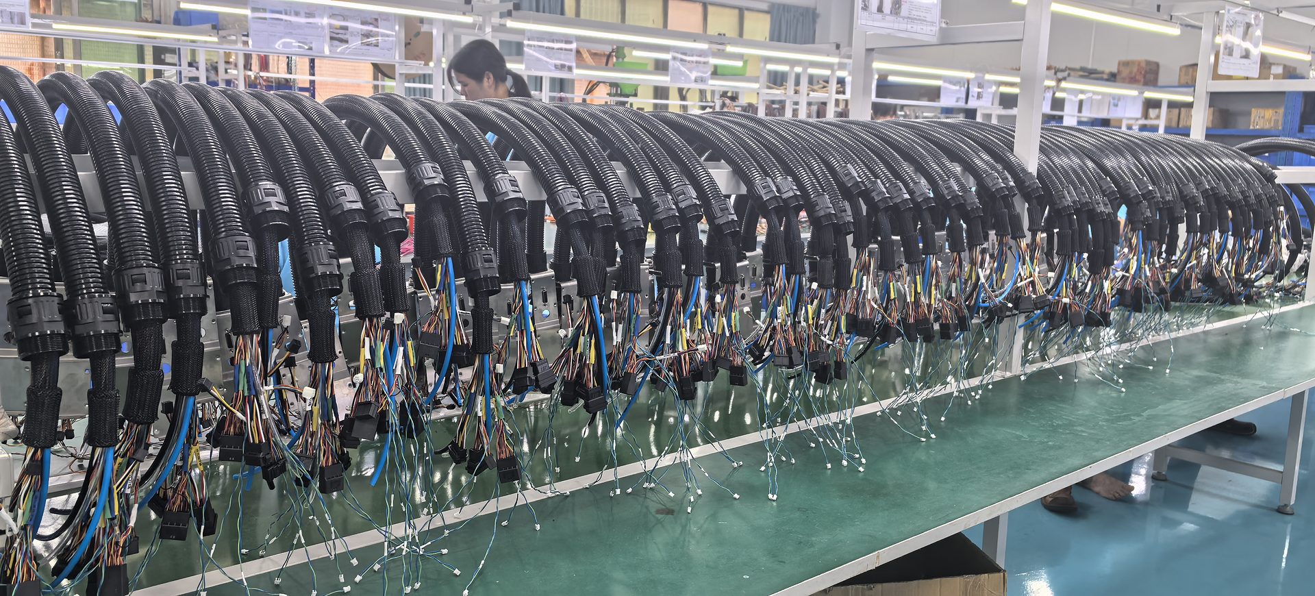 Finished wire harness assemblies on racks on the Linkssor production line